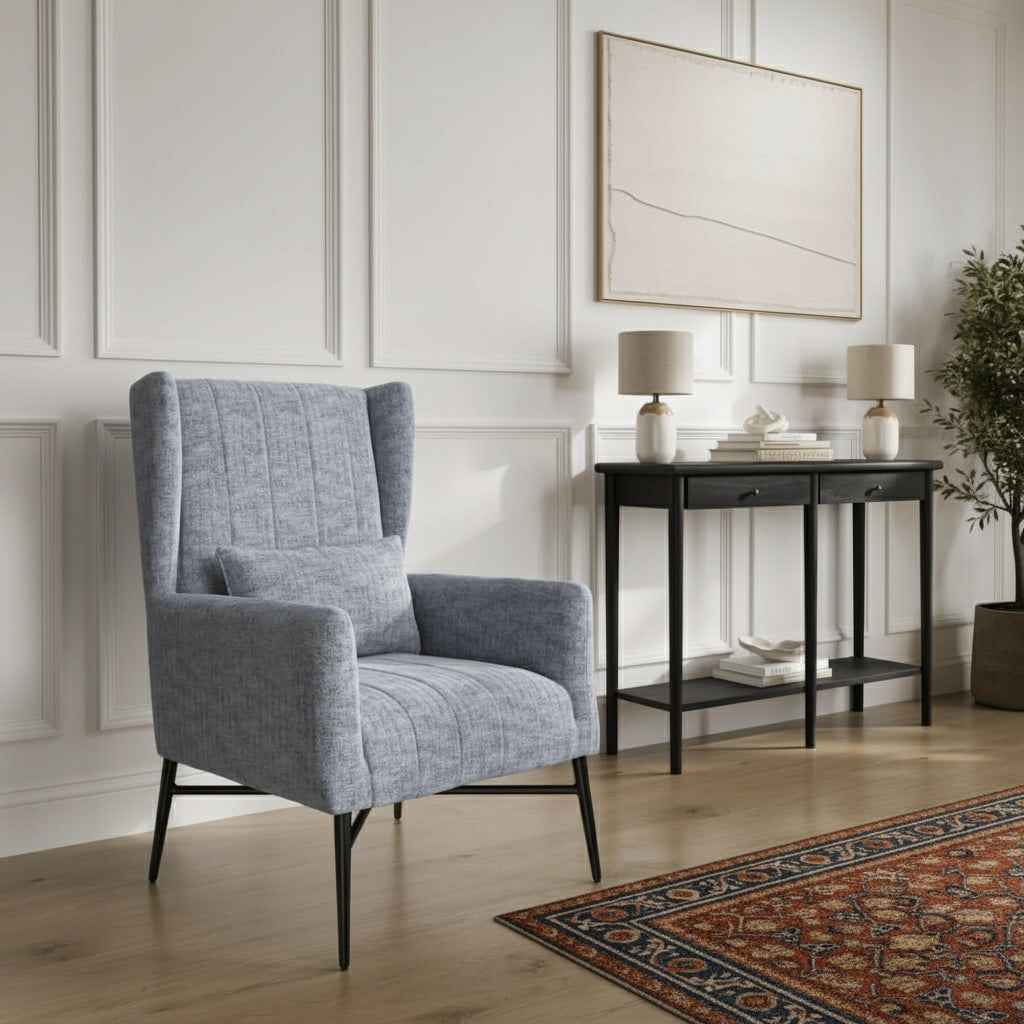 Grey armchair in a living room with a console table and decor items. Harry Christian Home Enya Armchair In Navy Herringbone Lifestyle Shot