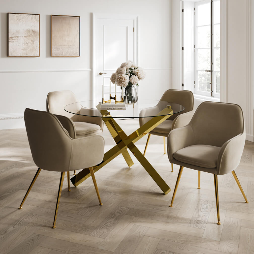 Modern dining room with a glass table and beige chairs on a wooden floor. The Harry Christian Home Gold Gatsby Dining Table paired with the Harry Christian Home Cosy range dining chairs in fawn upholstery and golden legs. Harry Christian Home Dining Room Furniture