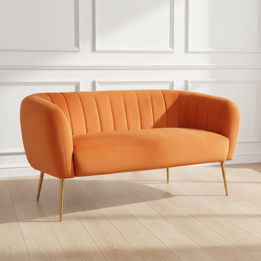 orange / burnt orange 2 seater sofa with gold legs.